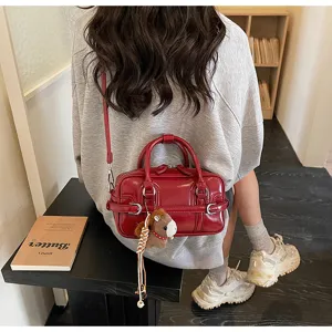 Red glossy PU leather shoulder bag for women, stylish crossbody bag with cute horse charm.