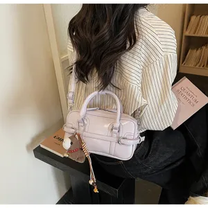 Detail shot of the light purple patent leather boston bag, stylish everyday crossbody accessory.