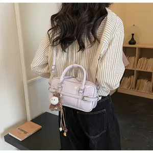 Detail shot of trendy light purple patent PU leather crossbody bag, stylish and chic style.