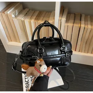 Black shiny PU leather women shoulder crossbody bag with cute horse charm and stylish design.