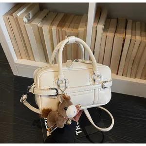 White PU leather crossbody bag with dual top handles and cute plush horse charm detail.