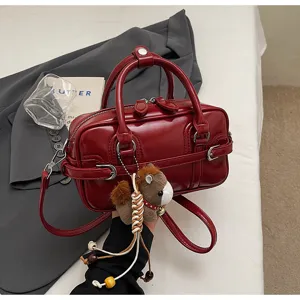 Red glossy PU leather small shoulder bag detail, stylish retro handbag with cute charm.