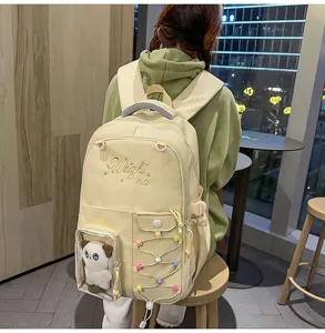 Cute large capacity school backpack with transparent ita bag pocket and cute cat plush doll detail.