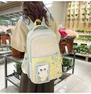 Large capacity color block student school backpack with cute window plush cat pendant for daily use