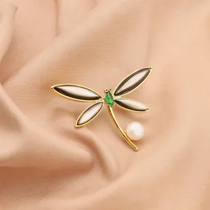 Elegant 18k gold plated dragonfly brooch with black shell wings, green zirconia and pearl.