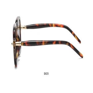 Side detail view of fashionable retro tortoiseshell square sunglasses with gold metal hinges.