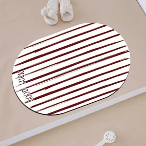 Oval bath mat with red white stripes and good luck print for home bathroom floor decor