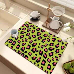 Detailed view of green leopard print diatomaceous earth dish drying mat for kitchen counter.
