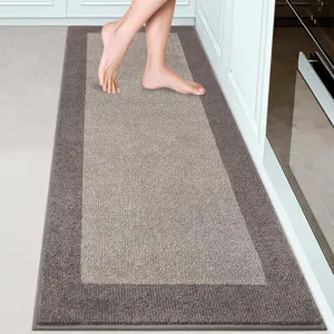 Close-up detail of the modern loop pile kitchen runner rug featuring soft grey tones.