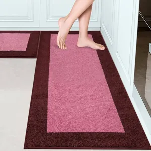 Close-up of soft loop pile kitchen rug featuring a chic two-tone pink and dark brown border.