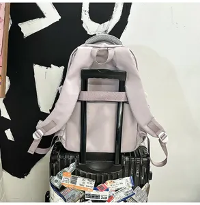 Light purple large capacity school backpack with luggage strap for student daily travel use.