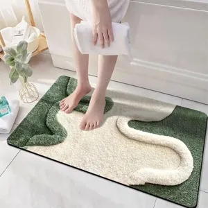 Detailed view of the soft fluffy green and white absorbent bath mat for bathroom floor.