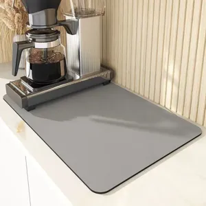 Grey coffee maker mat for kitchen countertop, absorbent silicone leather pad, heat resistant.