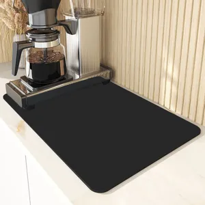 Black coffee maker mat detail, absorbent kitchen countertop drying pad and heat insulation pad.