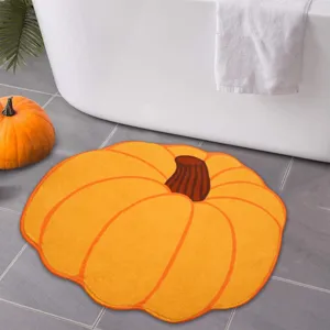Pumpkin shaped bathroom floor mat, soft fluffy anti-slip rug for cozy autumn home decor.