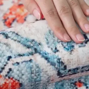Close-up detail of soft Persian style area rug showing plush texture and vibrant floral pattern.