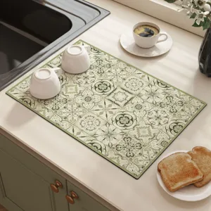 Close-up of green retro tile pattern kitchen dish drying mat, absorbent surface detail.