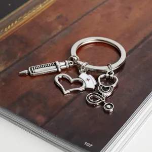 Medical keychain featuring nurse cap, stethoscope, syringe and heart charms in silver alloy.