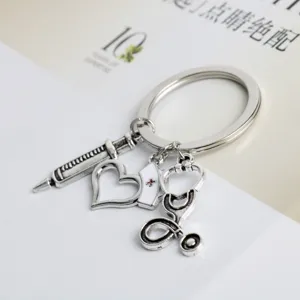 Medical theme keychain featuring syringe stethoscope nurse cap and heart charms in antique silver.