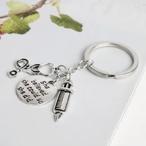 Medical theme metal keychain featuring stethoscope and syringe charms for nurse and doctor gift.