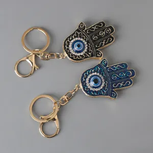 Detail view of Hamsa Hand Evil Eye keychains with rhinestones and enamel finish