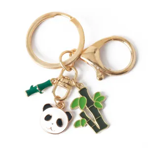Detailed macro shot of a cute panda and bamboo charm keychain with a polished gold finish