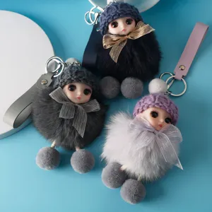 Macro view of three cute plush doll keychains in different colors with knit hats