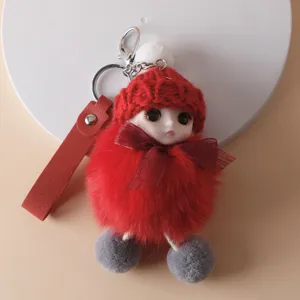 Detailed view of a cute red plush doll keychain featuring a soft fur body and a bow