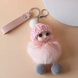Close-up of cute plush doll keychain with pink knitted hat and soft fur body pendant