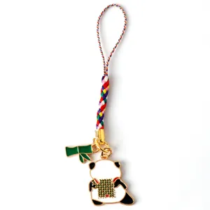 Close-up of cute panda keychain with bamboo charm and colorful braided cord