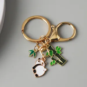Close-up of a cute Chinese panda and bamboo charm keychain with elegant gold-tone hardware