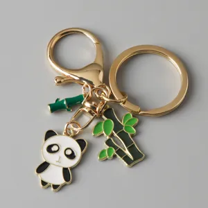 Detailed view of a cute panda charm and bamboo accents on a gold-tone metal keychain