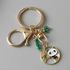 Detailed view of Chinese style panda keychain with bamboo charm and gold clasp