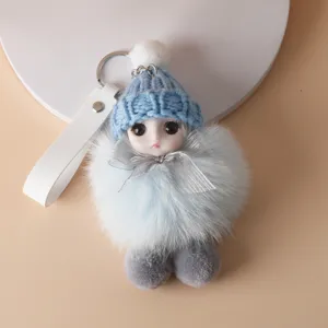 Cute plush doll keychain with blue knitted hat and fluffy light blue faux fur pom-pom