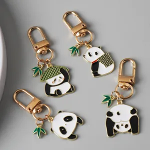 Detail showing four cute Chinese style panda keychains with green bamboo charms