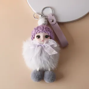 Close-up of cute plush doll keychain featuring a purple knit hat and white faux fur body