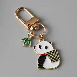 Detailed view of a cute enamel panda keychain featuring a green bamboo leaf charm