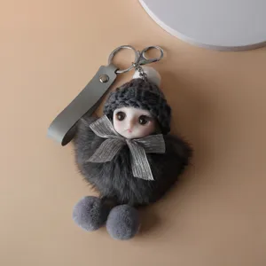 Close-up of cute plush doll keychain with grey knitted hat and soft fur body detail