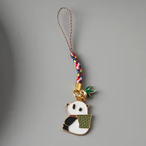 Detailed close-up of a cute enamel panda charm featuring a colorful braided strap cord