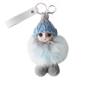 Cute plush doll keychain with blue knitted hat and silver bow detail for bag charm.