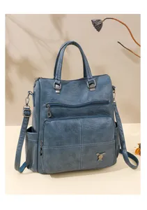 Close-up detail of the retro blue PU leather backpack front pocket and cute metal rabbit decoration.
