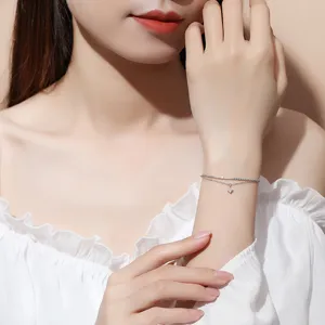 Exquisite delicate double layer silver bracelet with tiny square sparkling pendant detail.