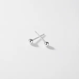 Close-up detail of S999 silver ball stud earring, minimalist design for daily wear.