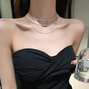 Close-up detail shot of a sparkling multi-layer silver choker necklace, elegant jewelry design.