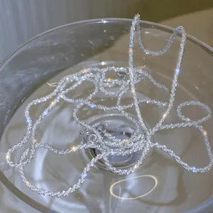Detailed close-up of a sparkling silver starry clavicle chain showing shimmering texture.