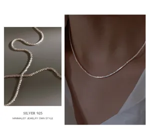 Detailed closeup view of the sparkling S925 silver shimmering minimalist clavicle chain.