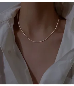 Delicate 925 silver sparkle chain necklace close-up, elegant clavicle chain design.