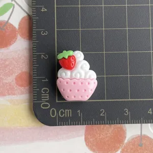 Resin strawberry cupcake charm detail shot, miniature DIY handmade phone case craft material.