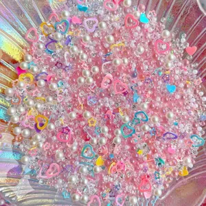 Colorful mixed DIY resin cabochons, pearls and rhinestones detail shot for craft projects.