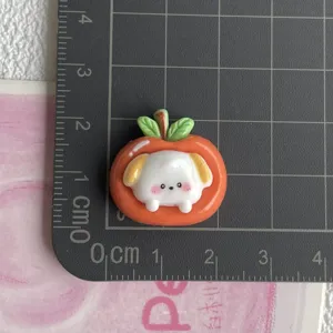 Cute resin dog orange fruit charm detail shot, ideal for DIY hair clips, shoes, and cup decor.
